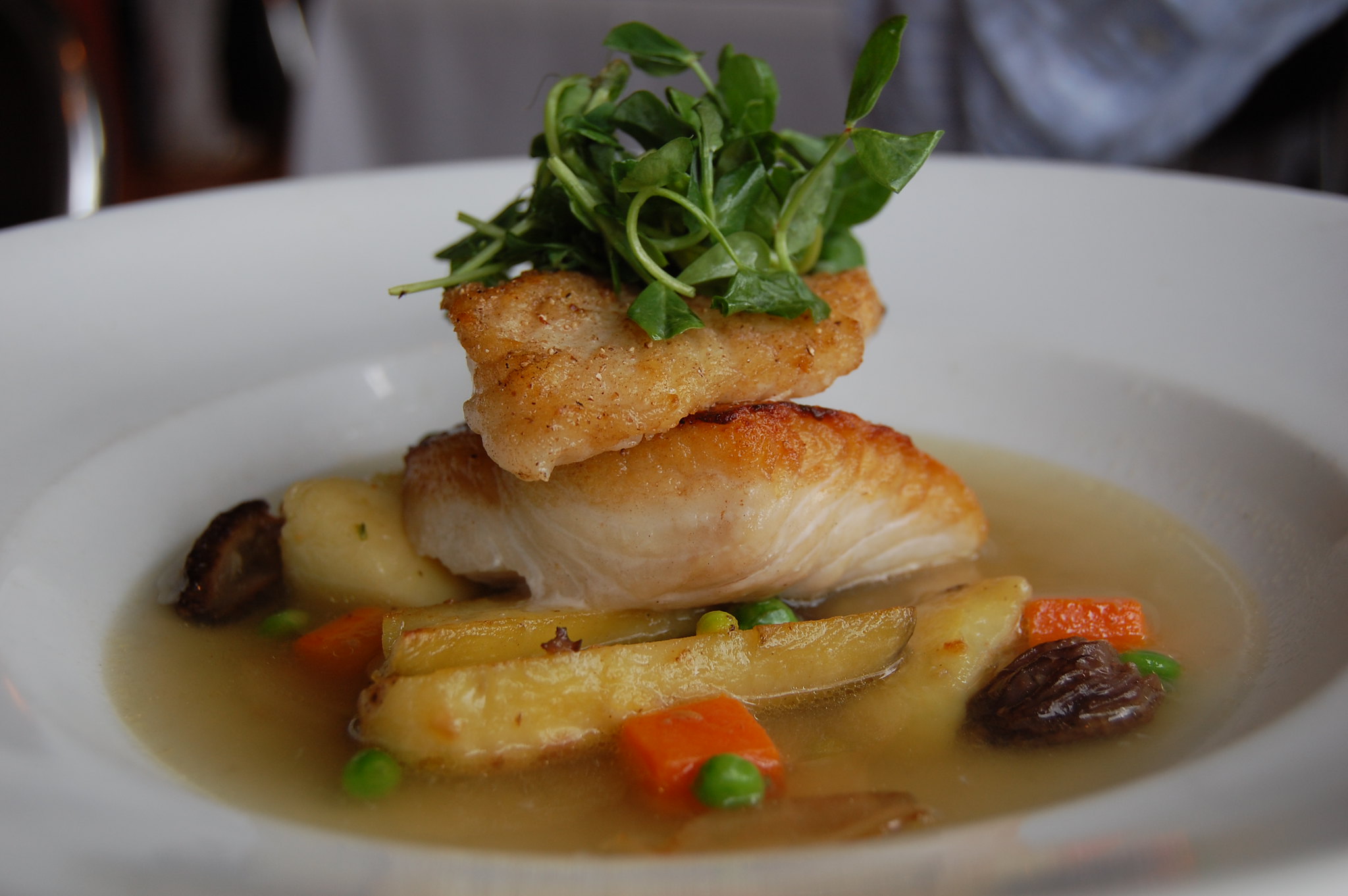 halibut with potatoes, broth, and garnish