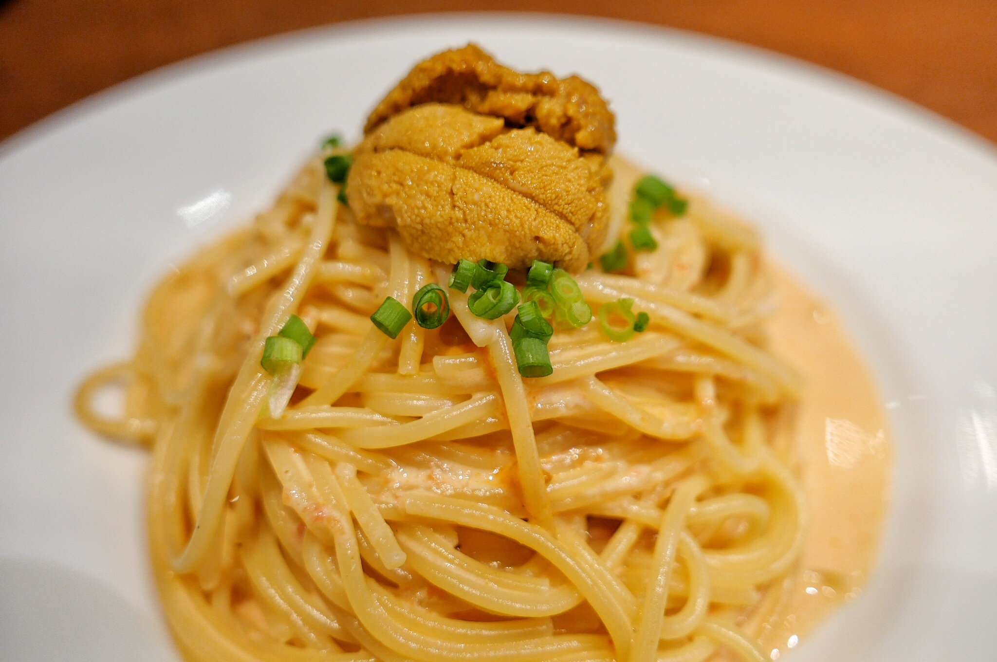 Uni pasta with green onion garnish