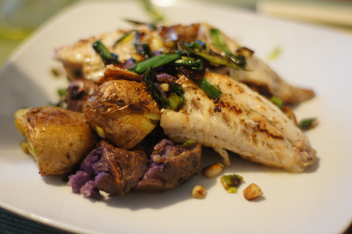 perch fillets with rainbow potatoes and green onion garnish