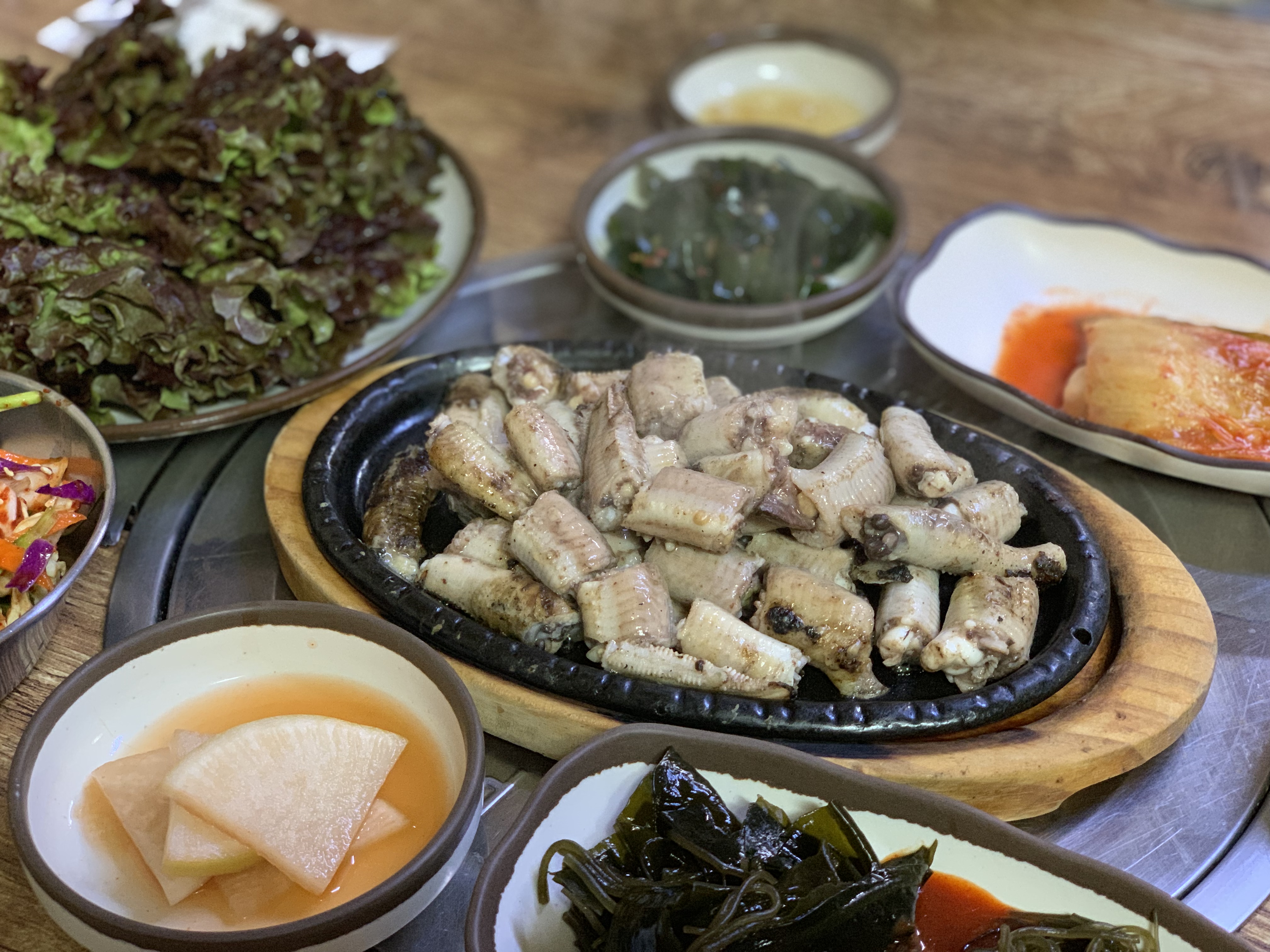 seasoned hagfish on hot plate with Korean side dishes