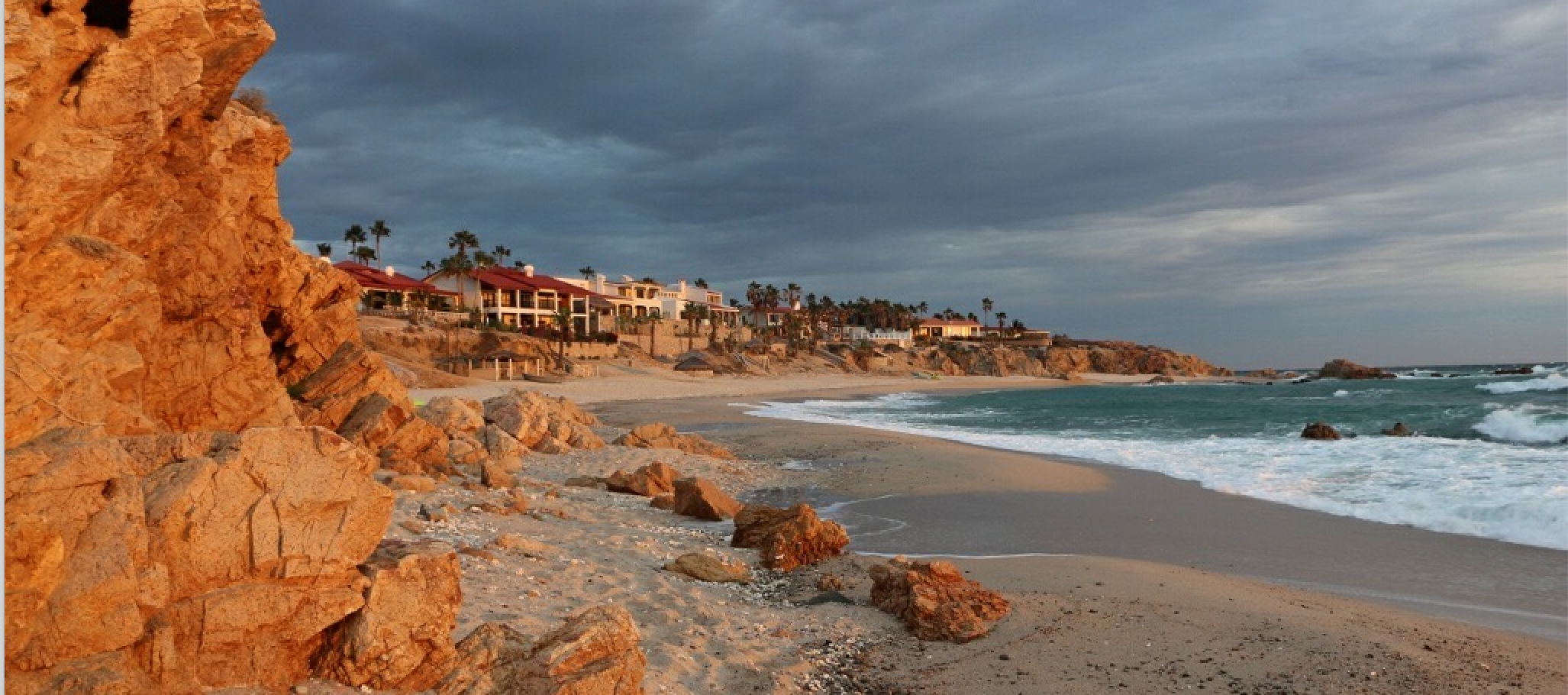 A photo overlooking a beach in Cardiff, California displaying the cliffs, beach, and coastal homes. Image courtesy of project interviewees.