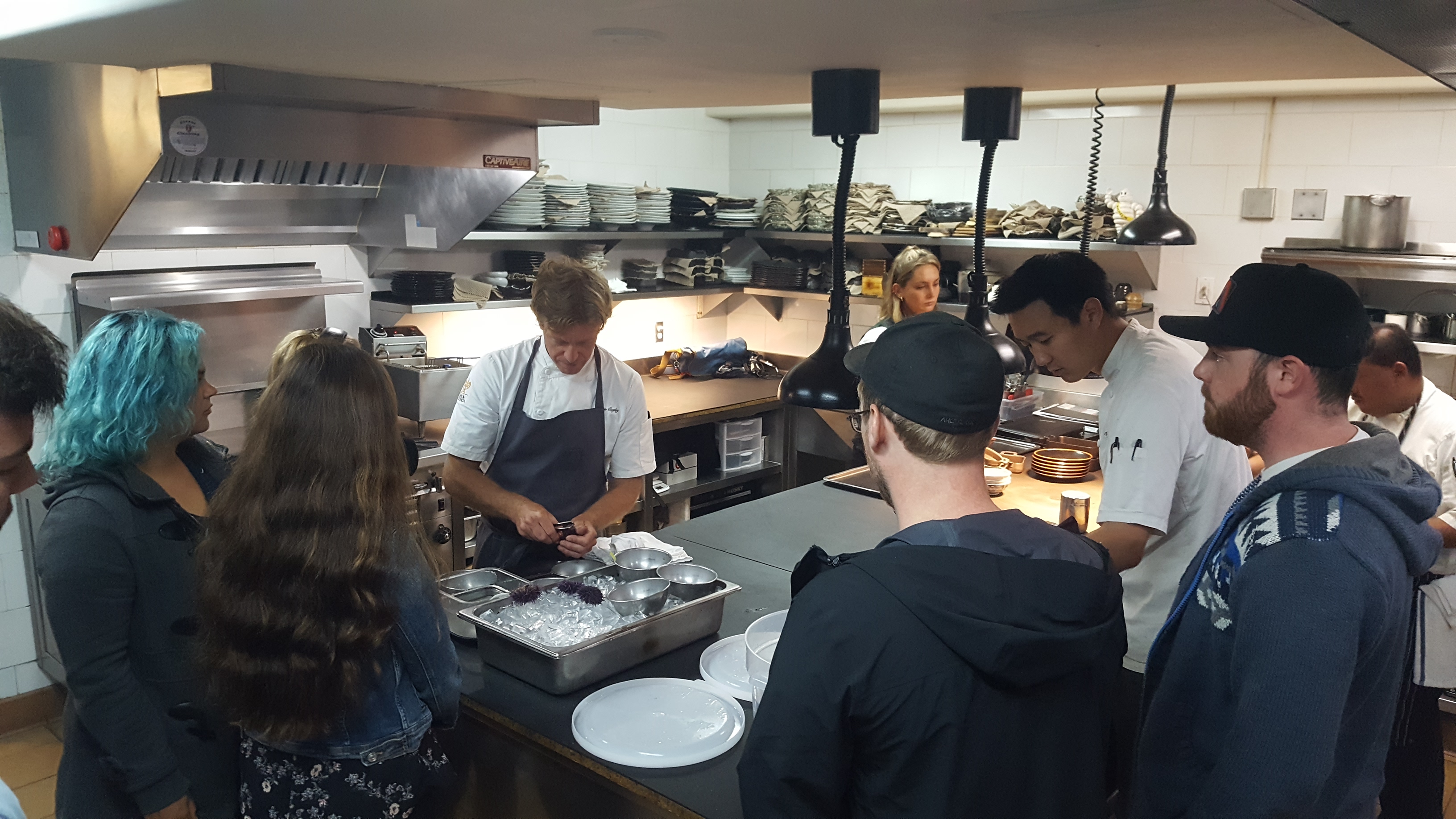 Students watching chef prepare urchins