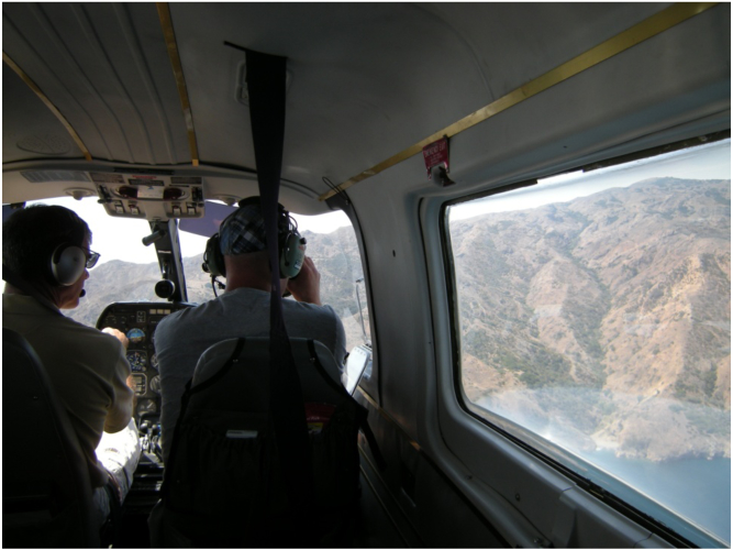 Spotter pilot Devin Reed (right) flies a transect while the passenger takes photos of sardine schools. Credit: Kirk Lynn/CDFW