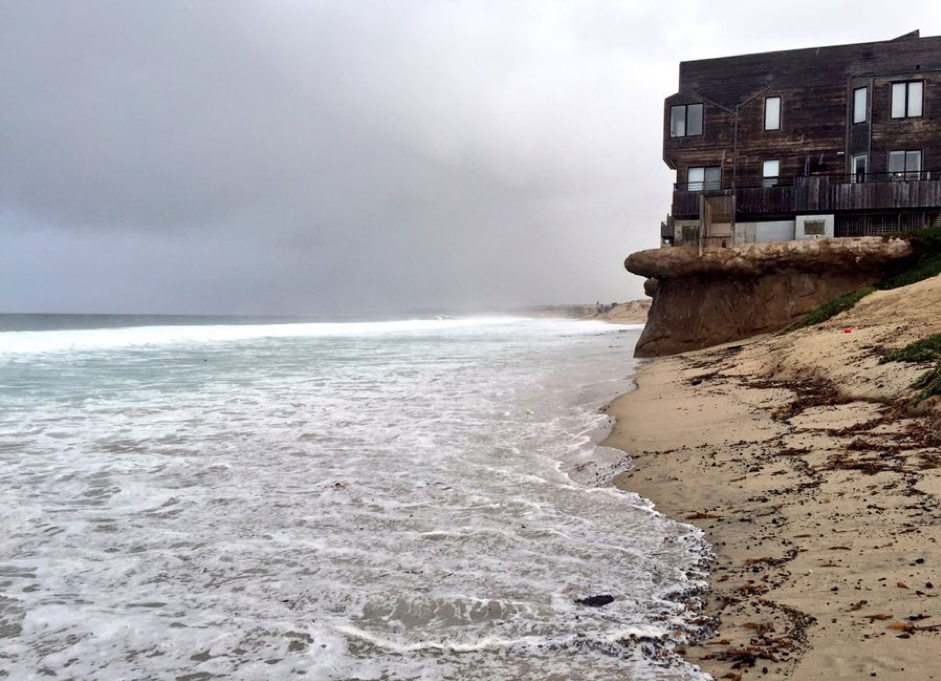 high tide approaching a seaside house