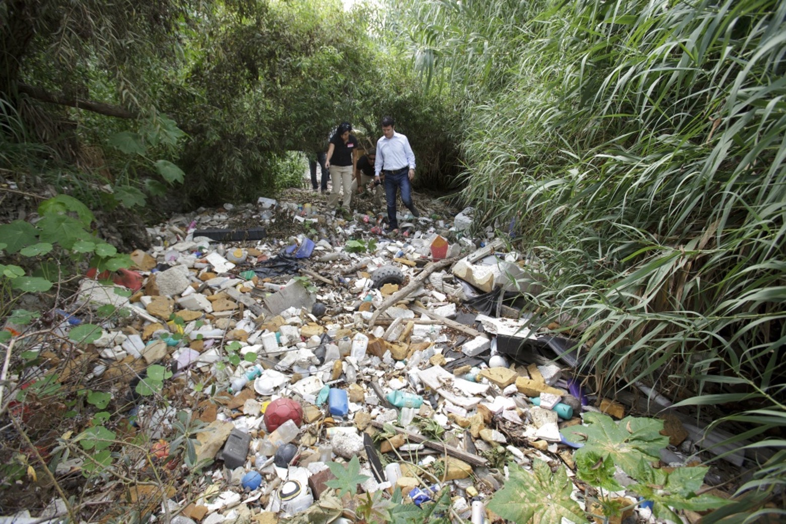 Aguirre and Jared Blumenfeld, Secretary CALEPA, walk through trash at Dairy Mart Road Bridge, Tijuana River Valley, U.S. Photo credit: Fay Crevoshay