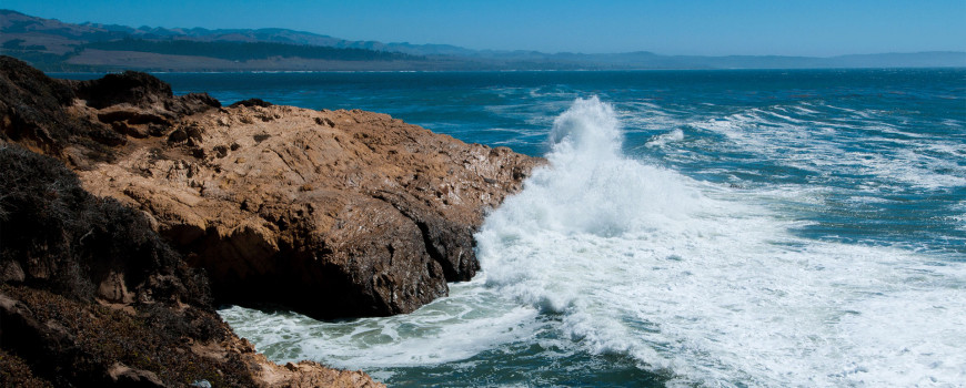 Image of waves hitting a rocky California shoreline. Credit: NOAA