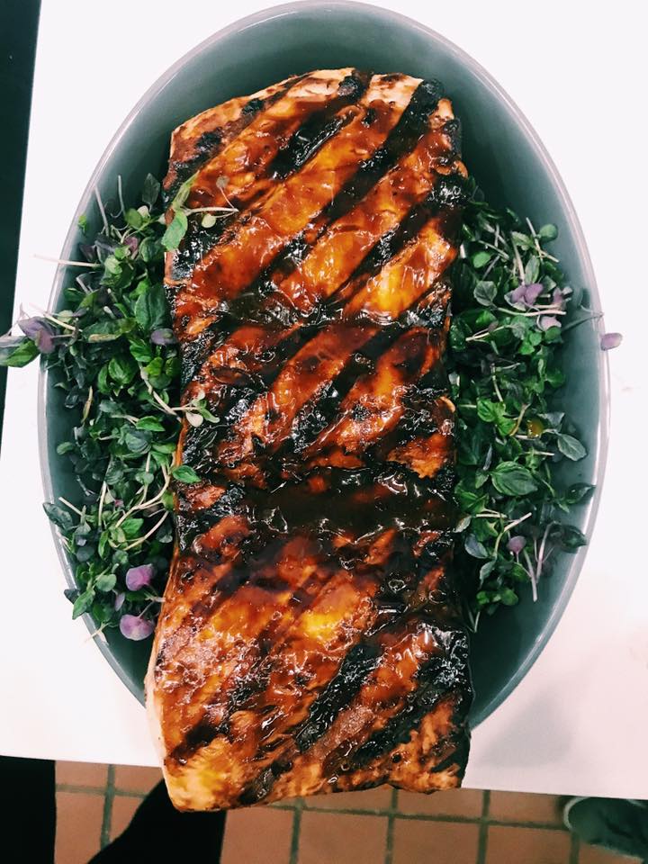 barbequed thresher shark on top a bed of greens