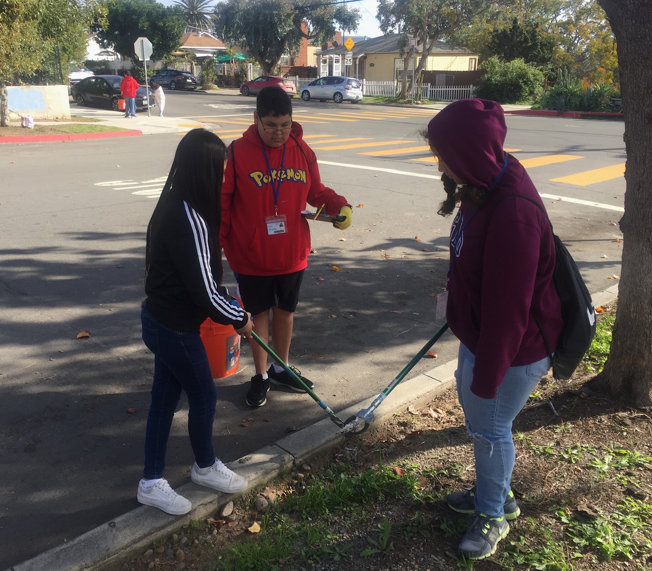 students picking up trash on a street