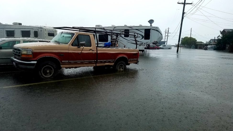 Vehicles parked on a flooded street