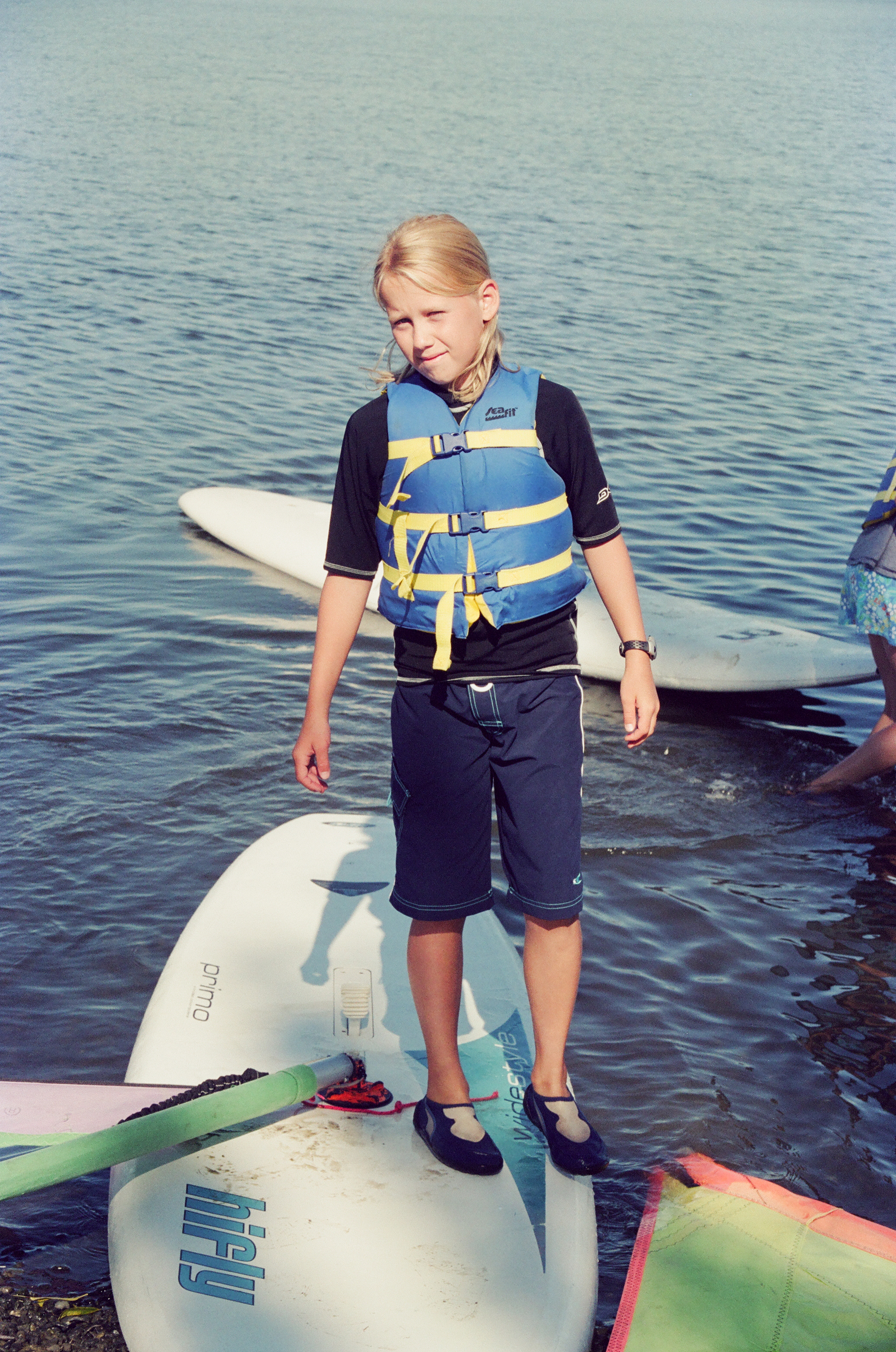 Viktoria as a young girl, standing on a windsurfing board