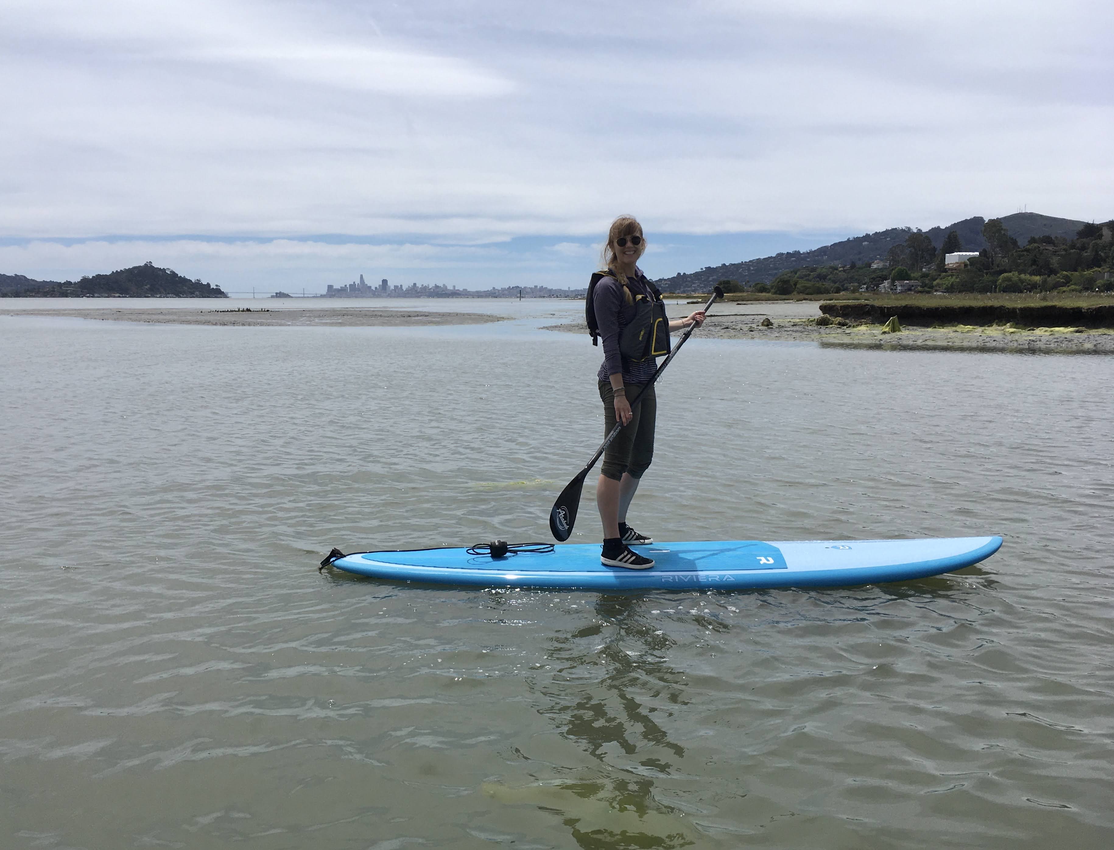 Viktoria standing on a paddle board