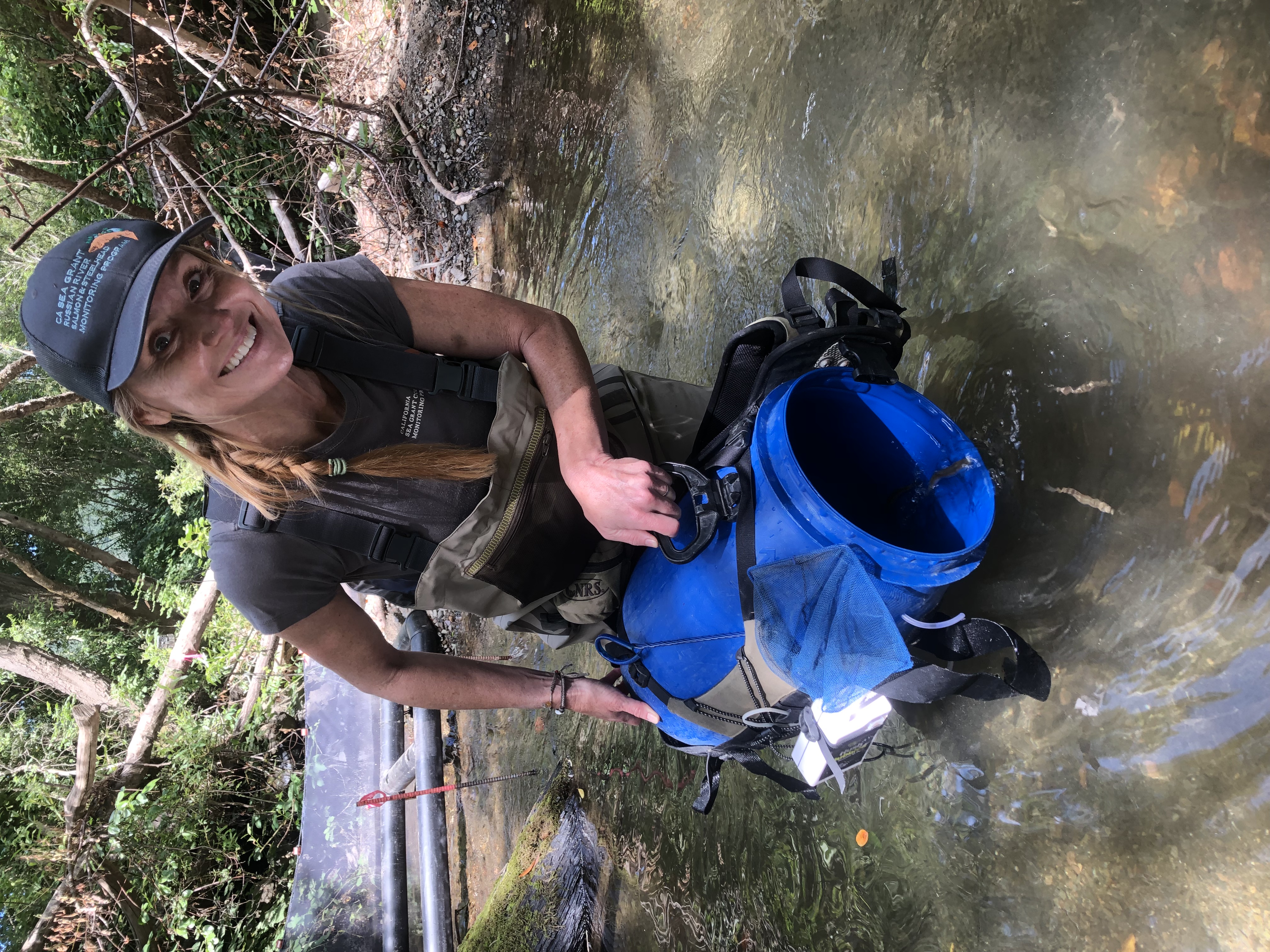 Sarah Nossaman Pierce releasing young-of-the-year coho into Porter Creek.